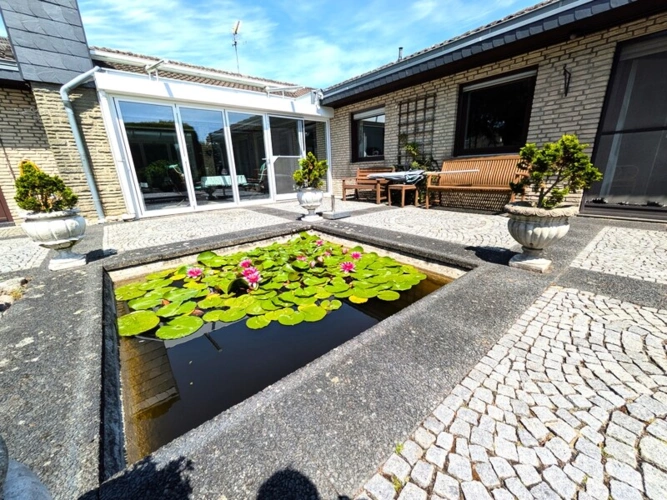 Der Wintergarten läßt sich weit zum Garten öffnen.